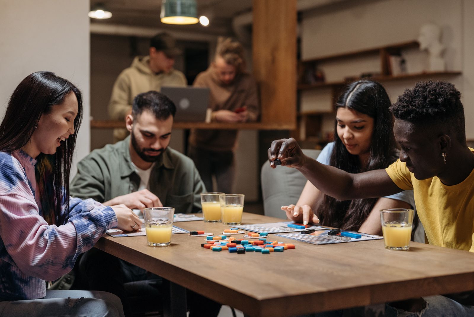 A group of people playing a board game together at a table