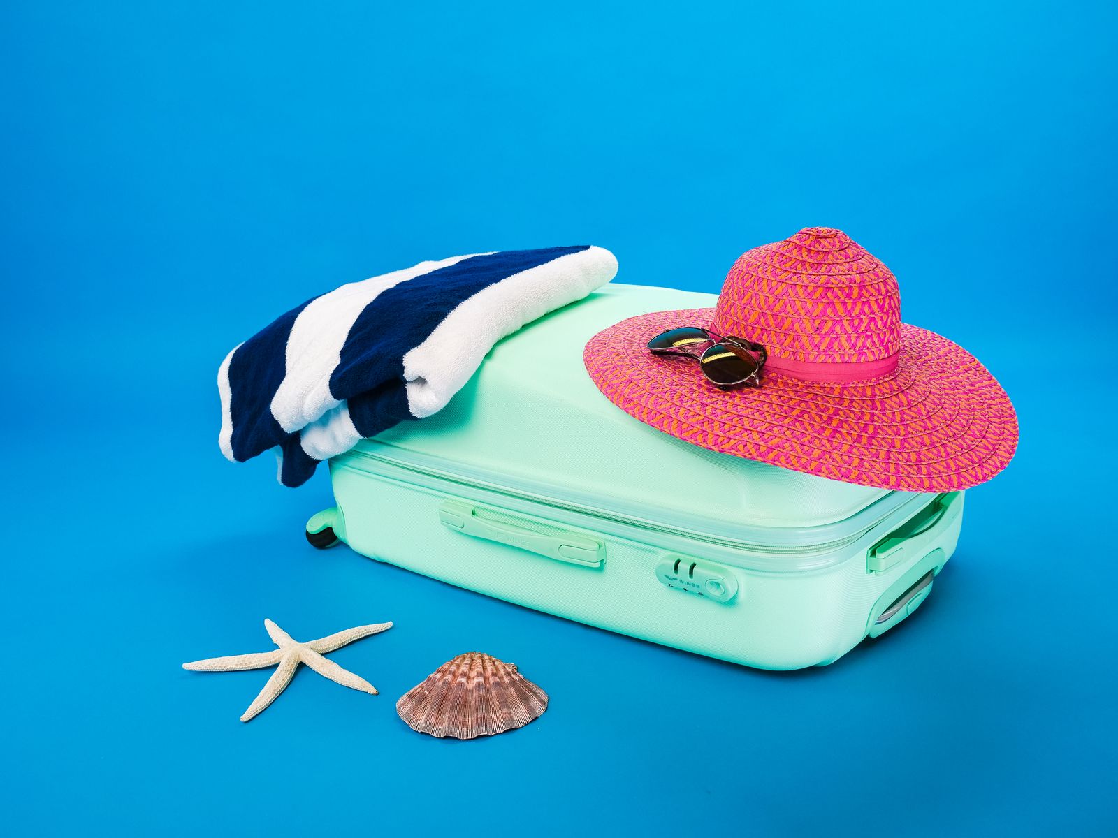 Roll-top dry bag on a sandy beach beside the water