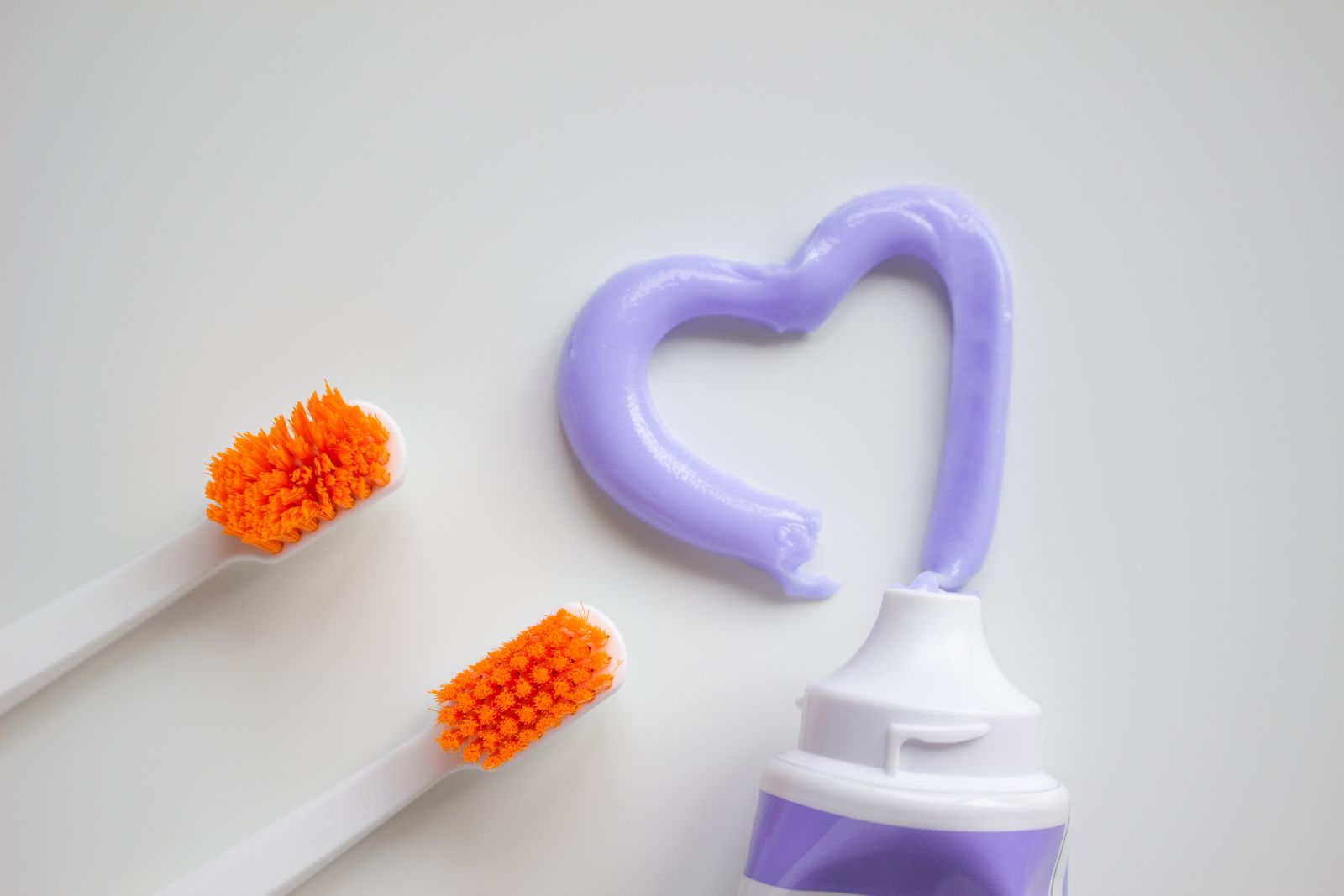 Water flosser, string floss, and air flosser lined up for comparison