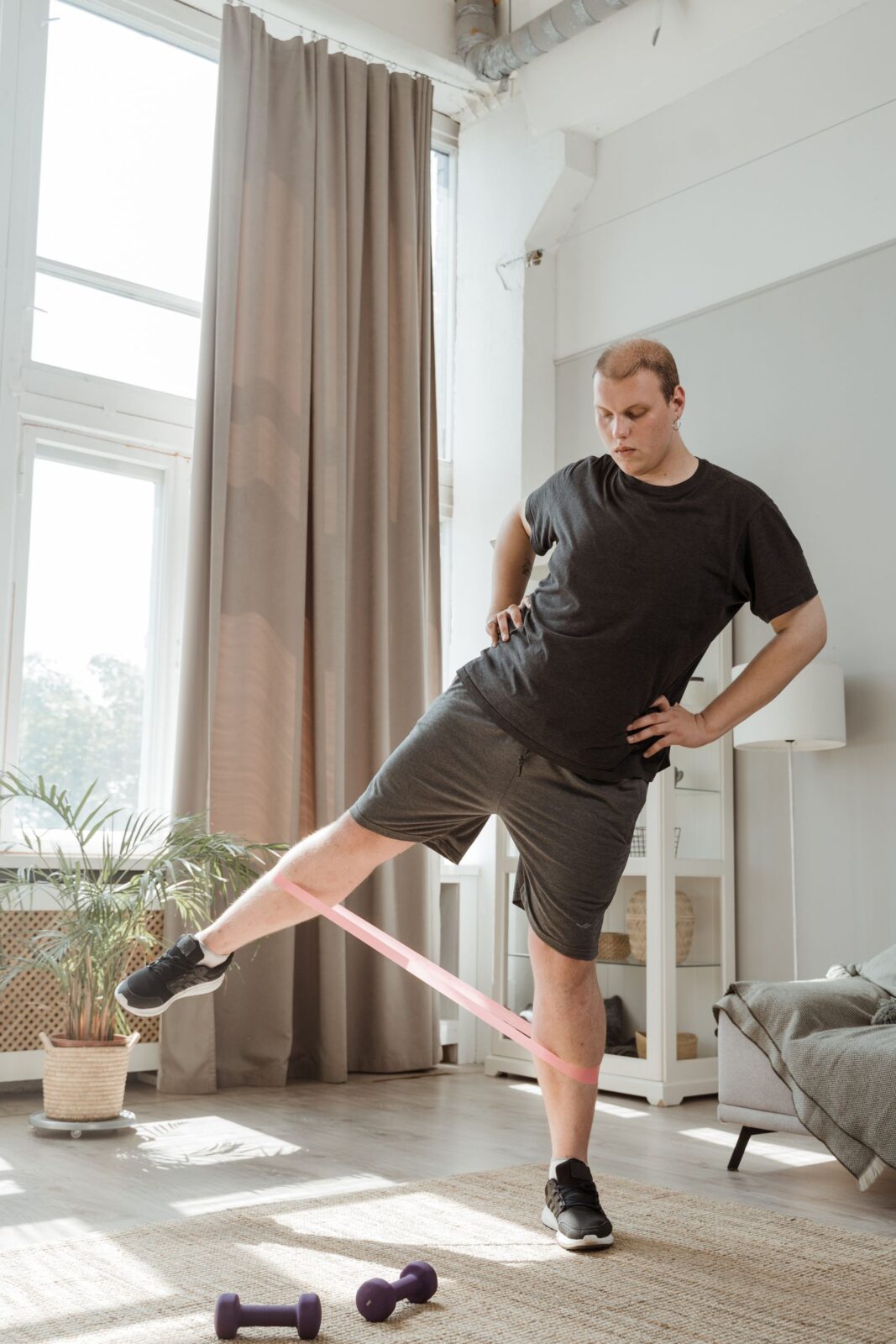 A man doing leg exercises with a rubber resistance band