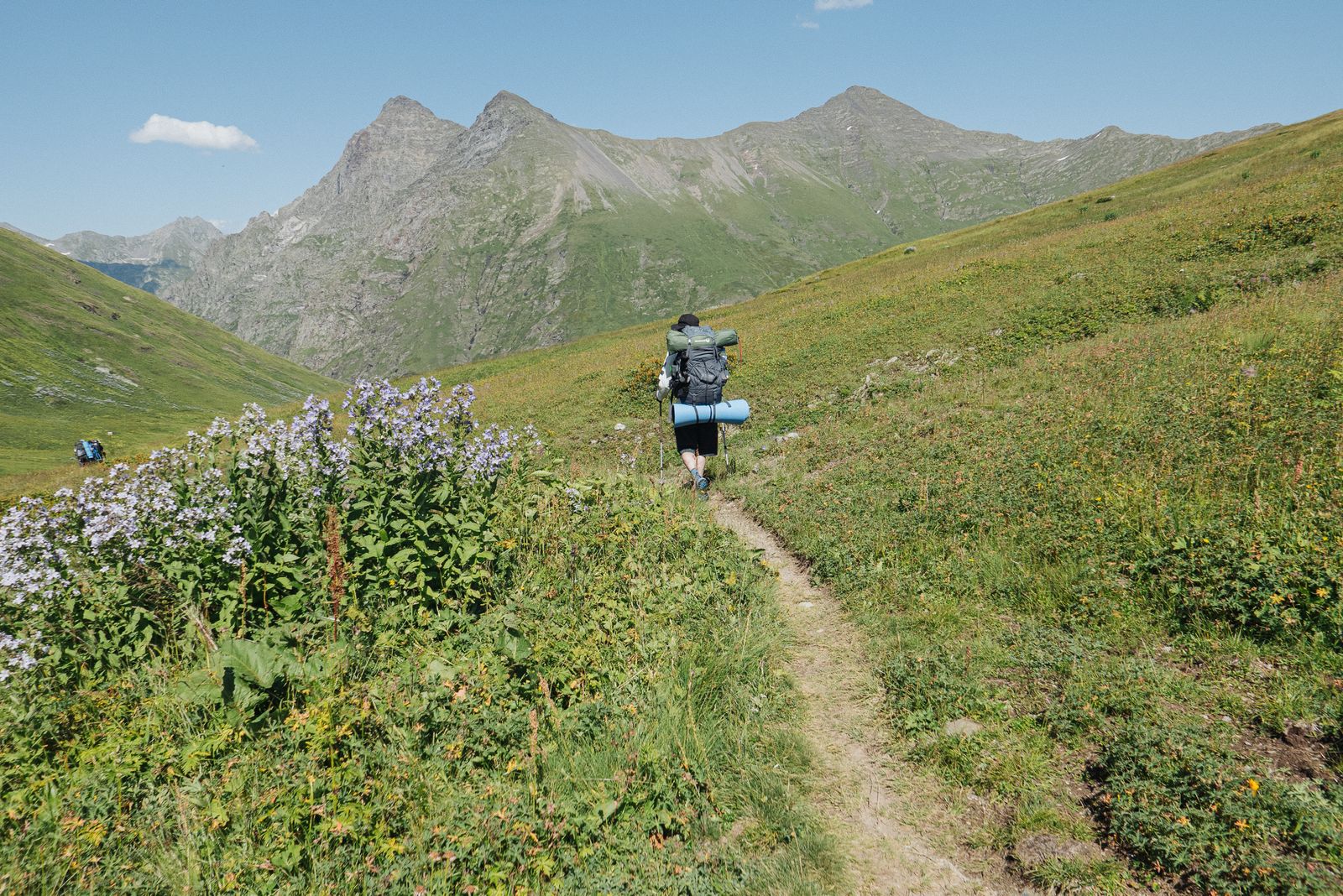 A person carrying a backpack going hiking on a trail