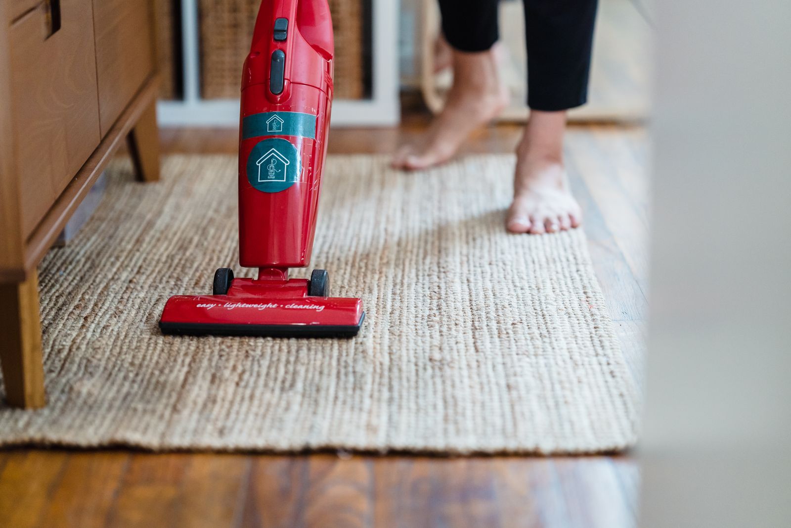A person vacuuming a living room carpet