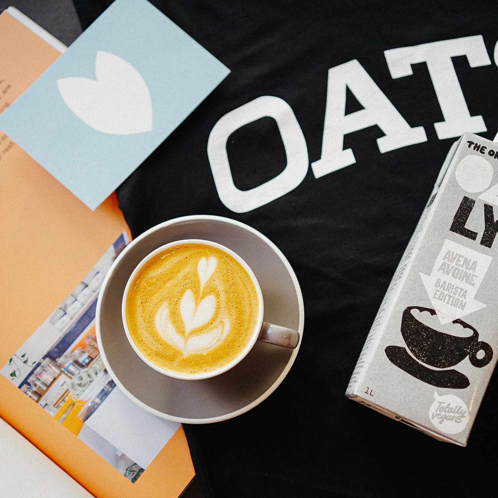 Plant-based milk poured into espresso forming latte foam