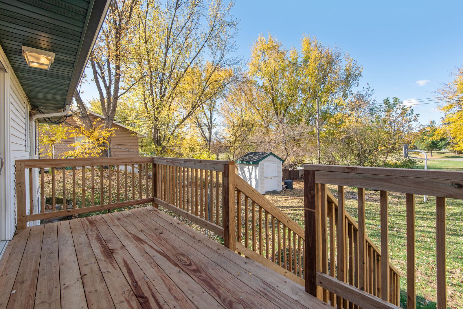 Empty wooden deck corner with room for outdoor storage furniture
