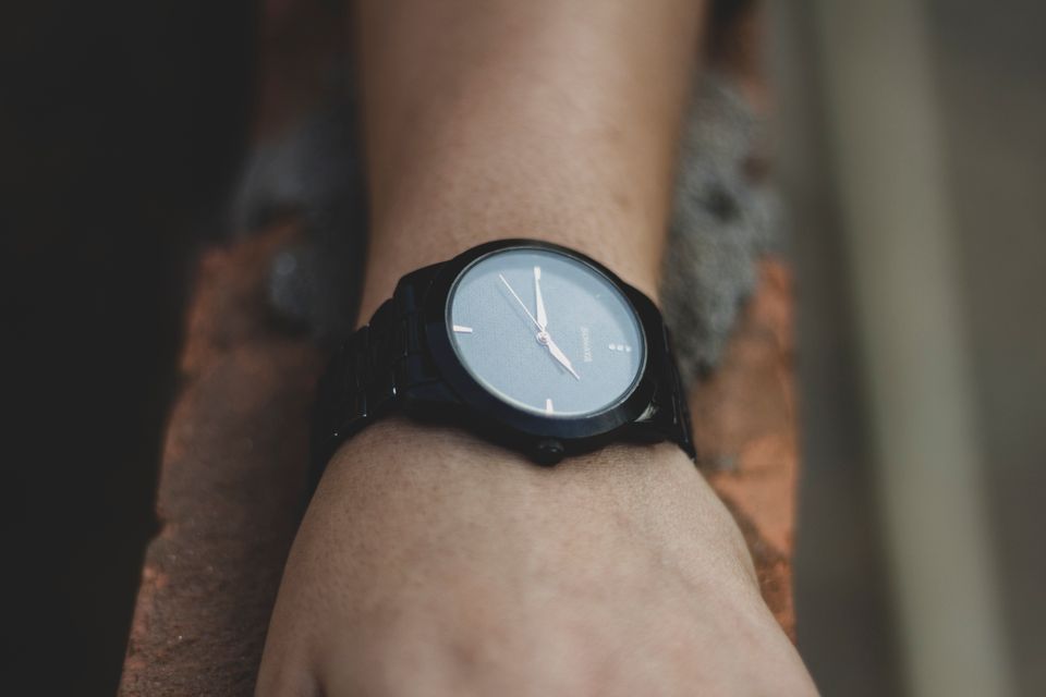 Minimalist black watch on wrist showcasing elegant design