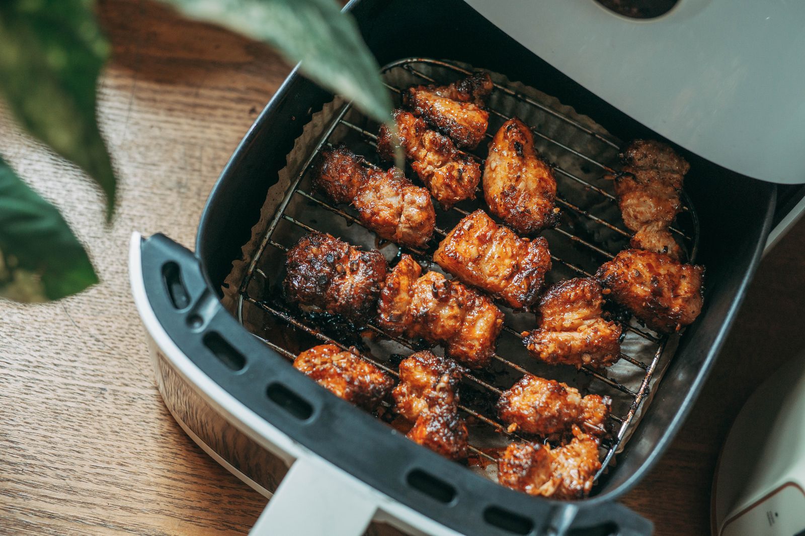 Crispy chicken pieces in an open air fryer basket