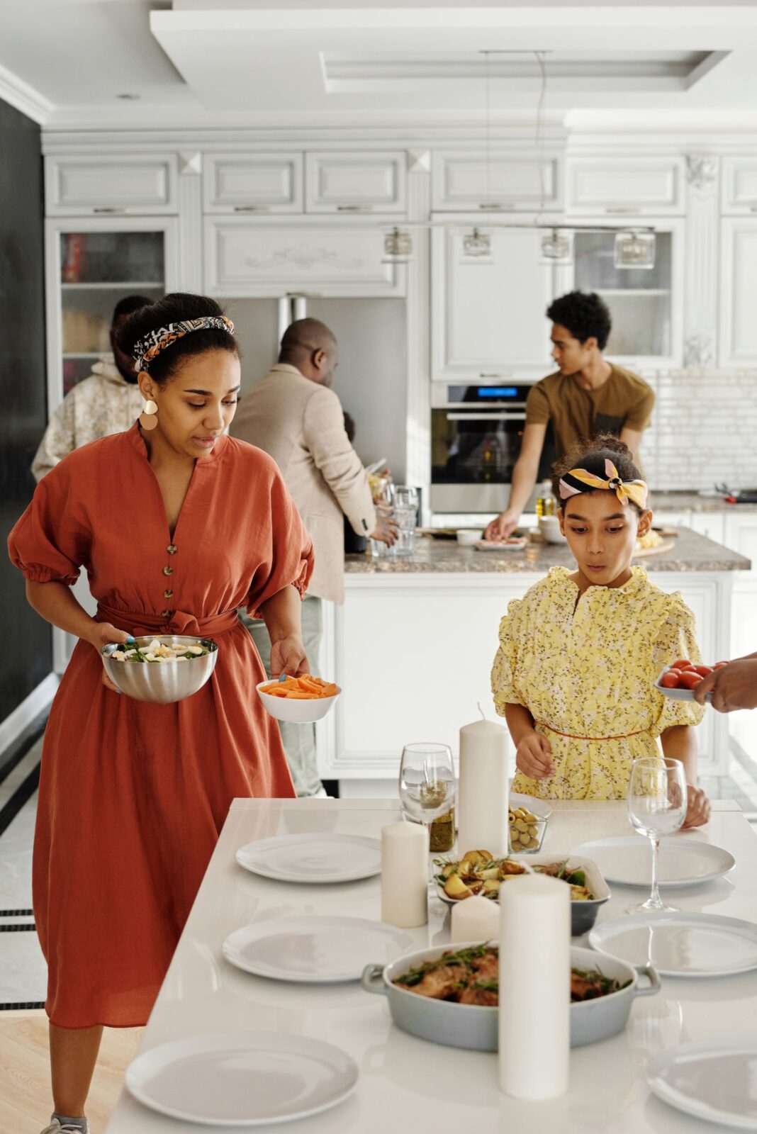 A family gathered in a modern kitchen preparing a meal together