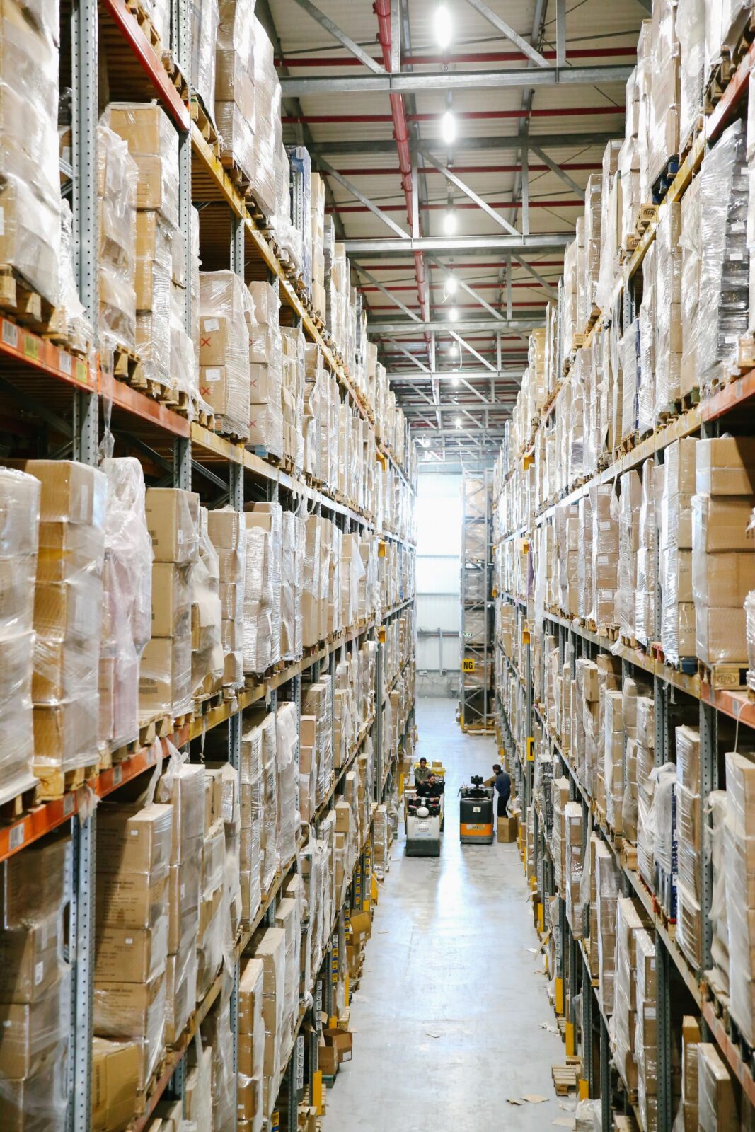 Rows of cardboard boxes stacked on tall warehouse shelving, representing bulk-buying replacement supplies