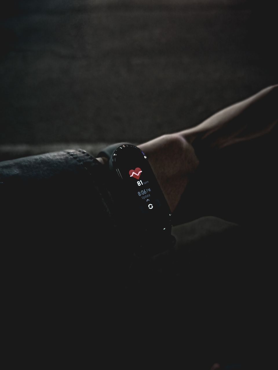 Close-up of a fitness tracker display showing vital signs data on a wrist